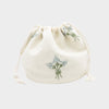 White drawstring pouch with floral embroidery on a white background