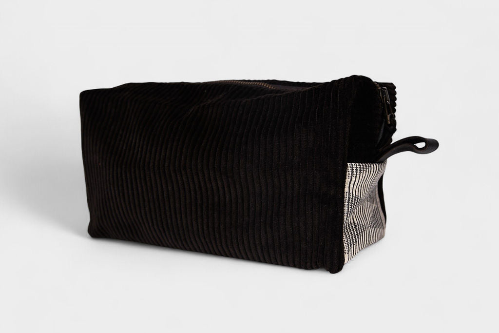 The SB Bag - Espresso Corduroy is a rectangular bag featuring a YKK metal zipper on top and a small fabric loop handle at one end, shown against a plain white background.