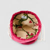 The Poppy Bag Fuscia Velvet is a fuchsia velvet drawstring pouch with a deep red exterior, cream upcycled linen lining, and green-red botanical print, featuring an inner ABADIR label.
