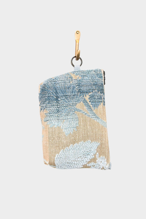 Introducing the Sky Leaf, now available at Pierre Lafond—a small rectangular jacquard pouch with a blue leaf pattern on beige, featuring a leather strap and metal hook.