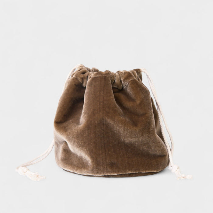 The Poppy Bag- Cocoa Velvet Vine, made from upcycled designer fabric, features cocoa velvet with cream drawstrings. Slightly crumpled for a textured look, it sits on a light gray background.