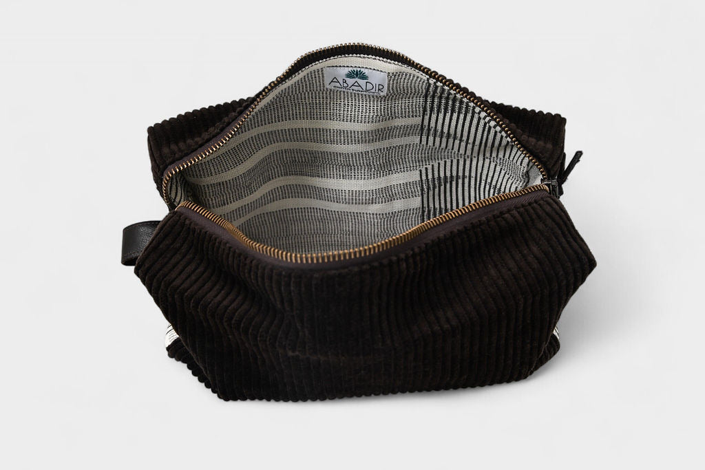 The SB Bag - Espresso Corduroy is a small bag with striped fabric lining, a white ABADR label with tree logo inside, and a durable YKK metal zipper.