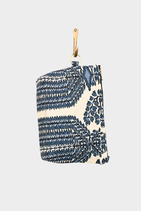 The Mini Mouse Pouch- Indigo Link, a designer cotton pouch with a blue and white leaf pattern, hangs from a tan leather strap against a plain light background.