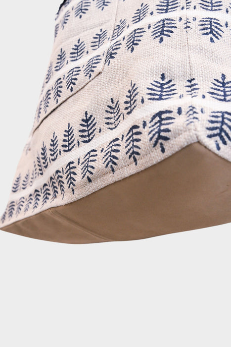 Close-up of the Fern and Clay tote—AVAILABLE AT ABADIR (contact for details)—featuring indigo leaf block print on beige fabric with a solid light brown base, photographed on a white background.